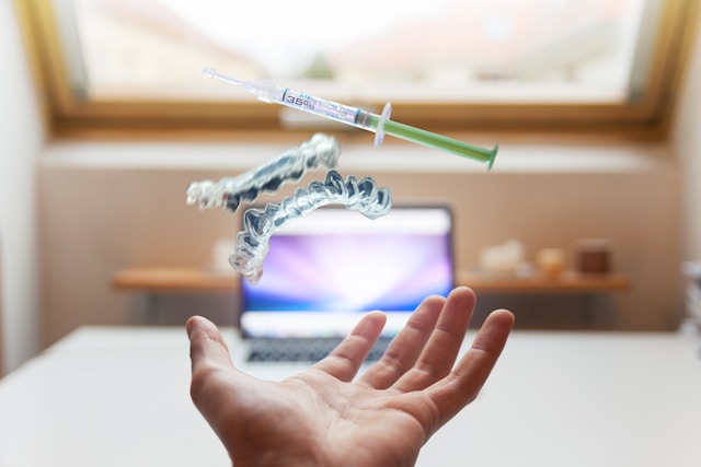 medical tourism symbol as open palm with syringe and regenerative cells floating above